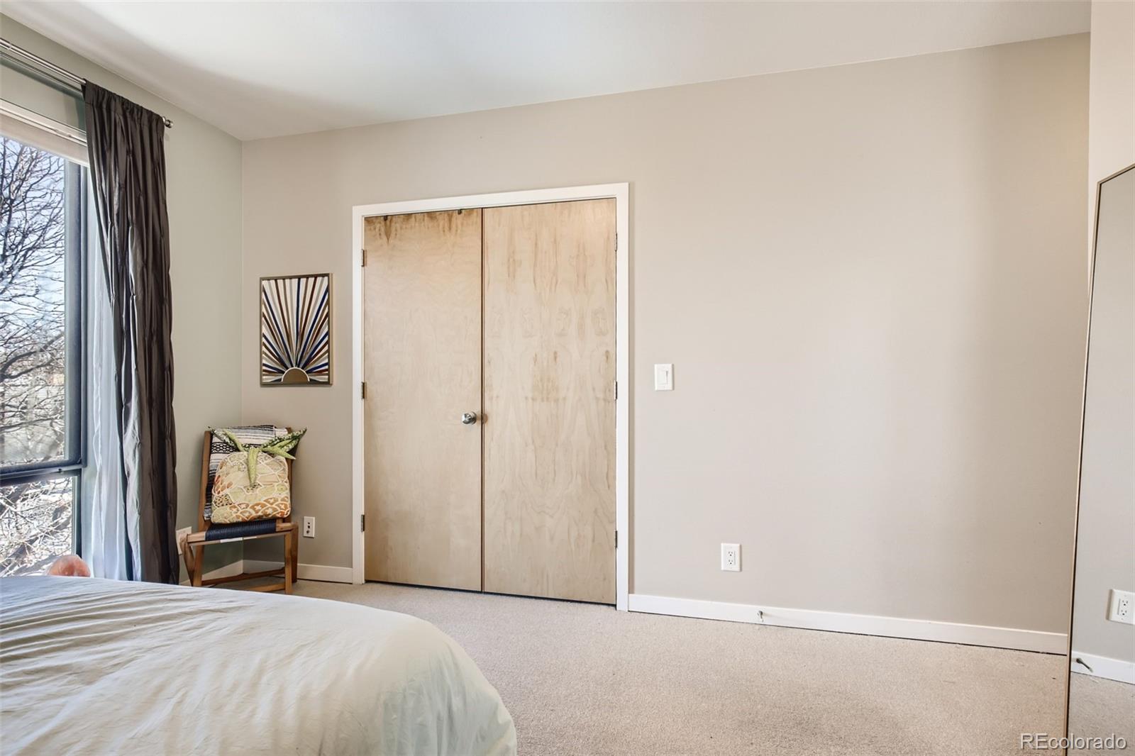 826 25th Street Denver, CO 80205 - Photo 15 of 23 a bedroom with a bed and a painting on the wall
