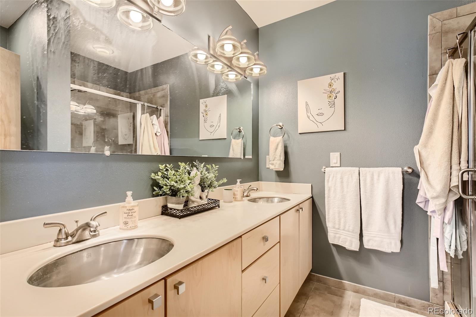 826 25th Street Denver, CO 80205 - Photo 16 of 23 a bathroom with a sink and a mirror
