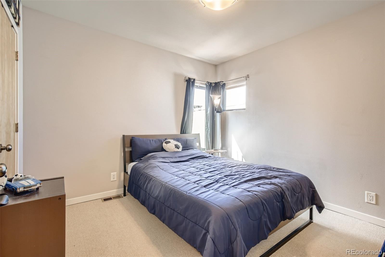 826 25th Street Denver, CO 80205 - Photo 17 of 23 a bedroom with a bed and a chandelier