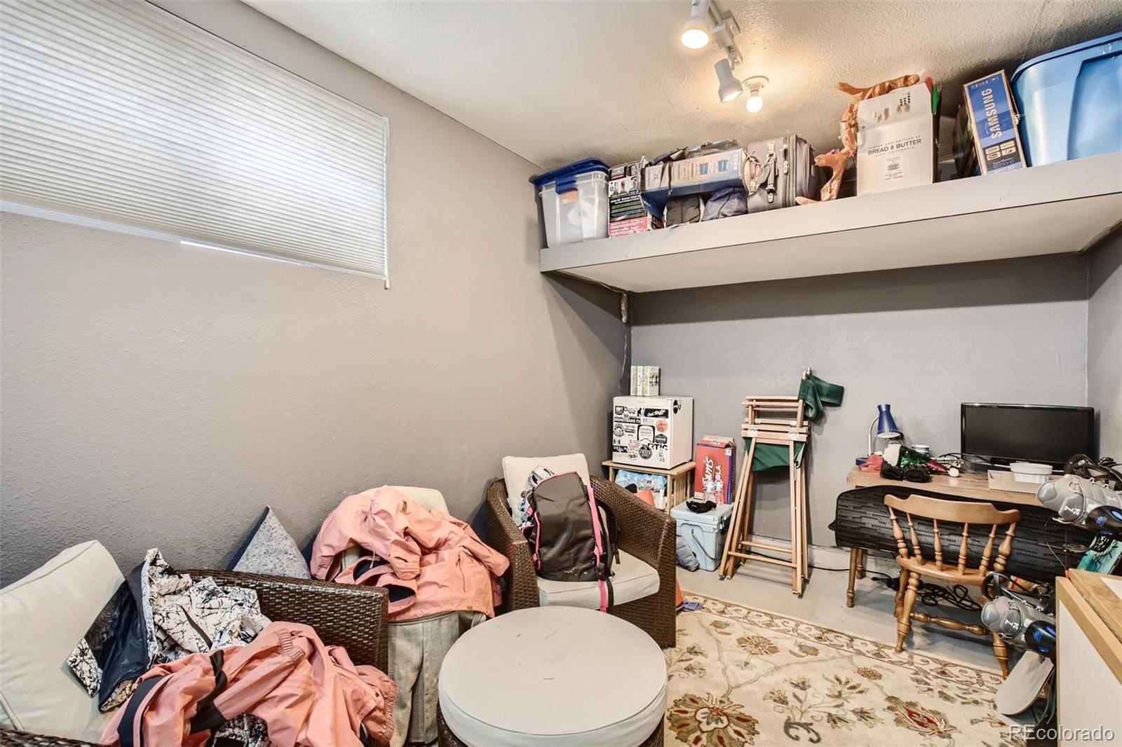 826 25th Street Denver, CO 80205 - Photo 21 of 23 a bedroom with furniture and a book shelf