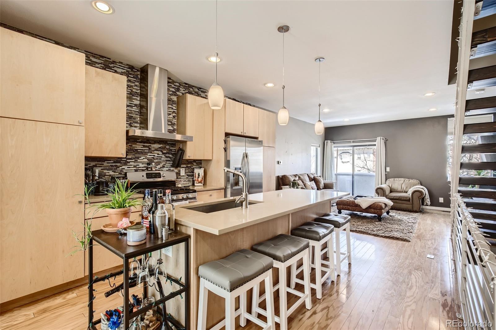 826 25th Street Denver, CO 80205 - Photo 7 of 23 a large kitchen with a counter space a sink appliances and cabinets