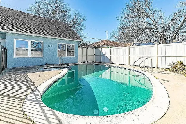 a view of a swimming pool with a patio