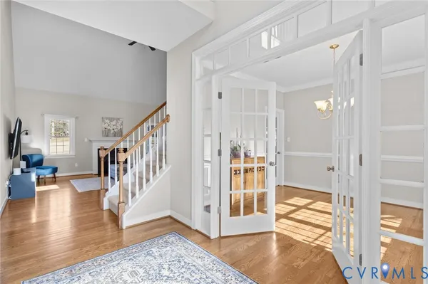 a spacious bedroom with a bed and a chandelier