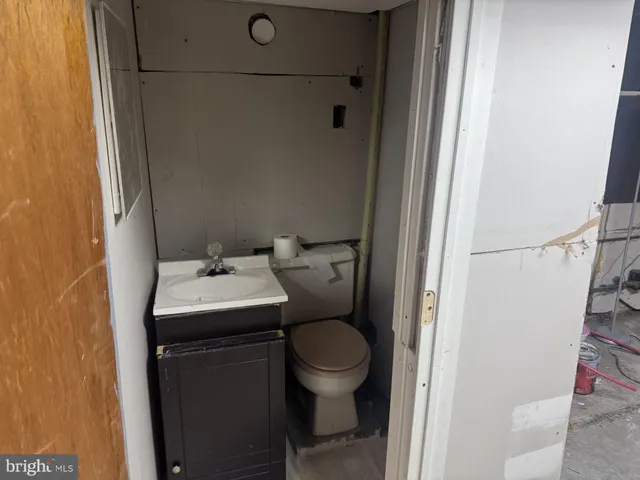 a bathroom with a sink toilet and a mirror