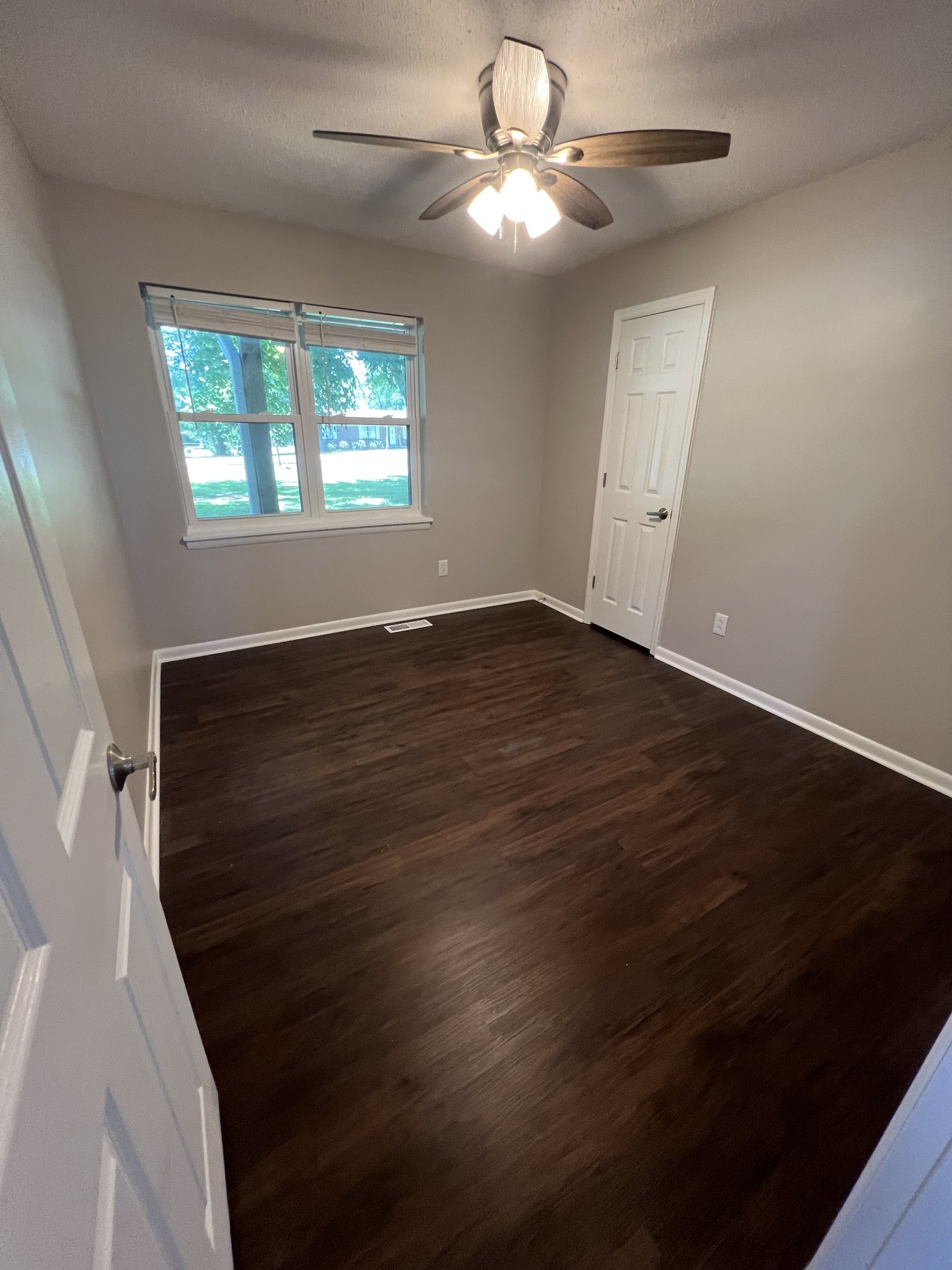 1846 Patrick Road Pulaski, TN 38478 - Photo 18 of 26 a view of an empty room with wooden floor and a window