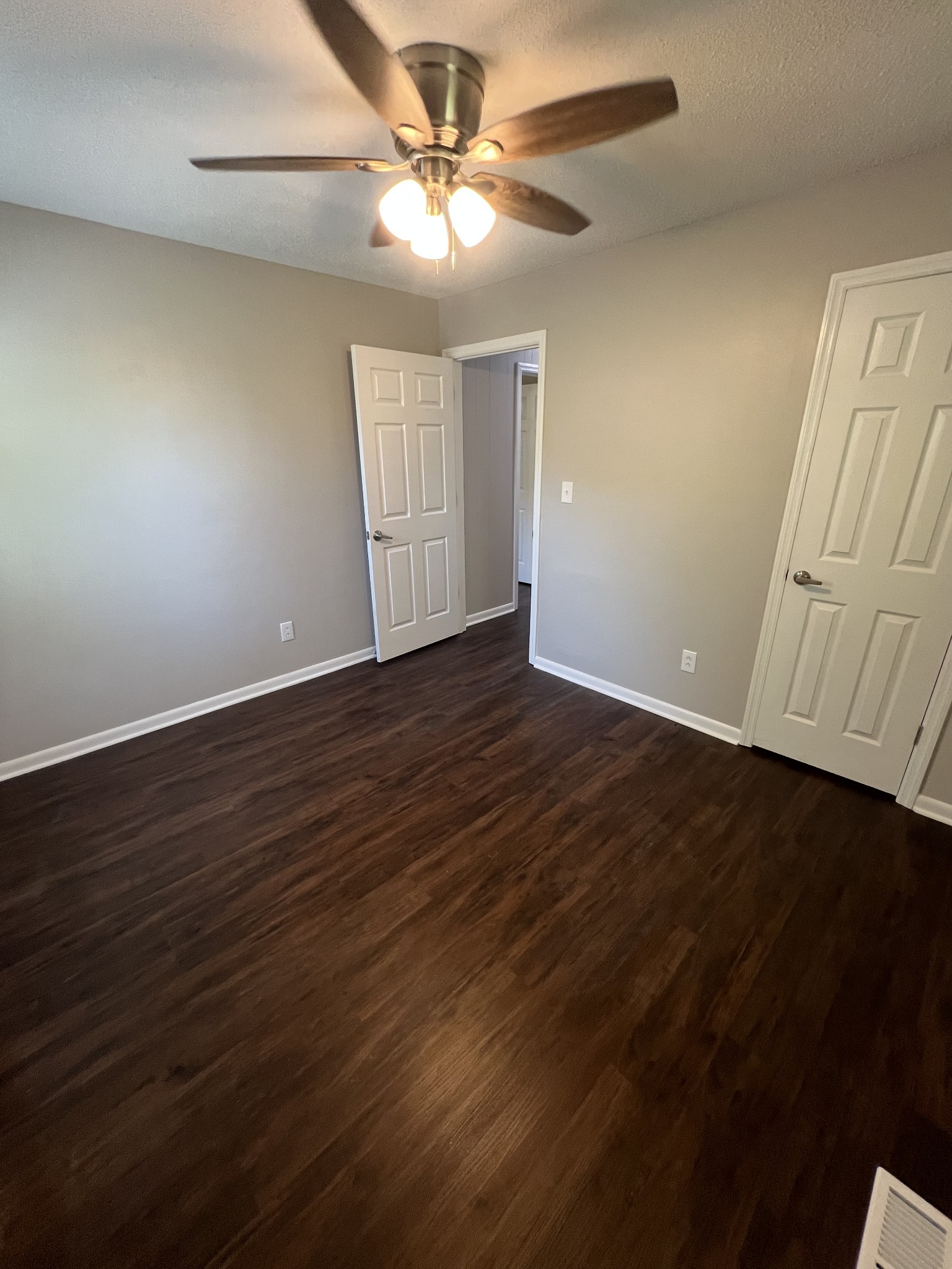 1846 Patrick Road Pulaski, TN 38478 - Photo 22 of 26 an empty room with wooden floor fan and windows
