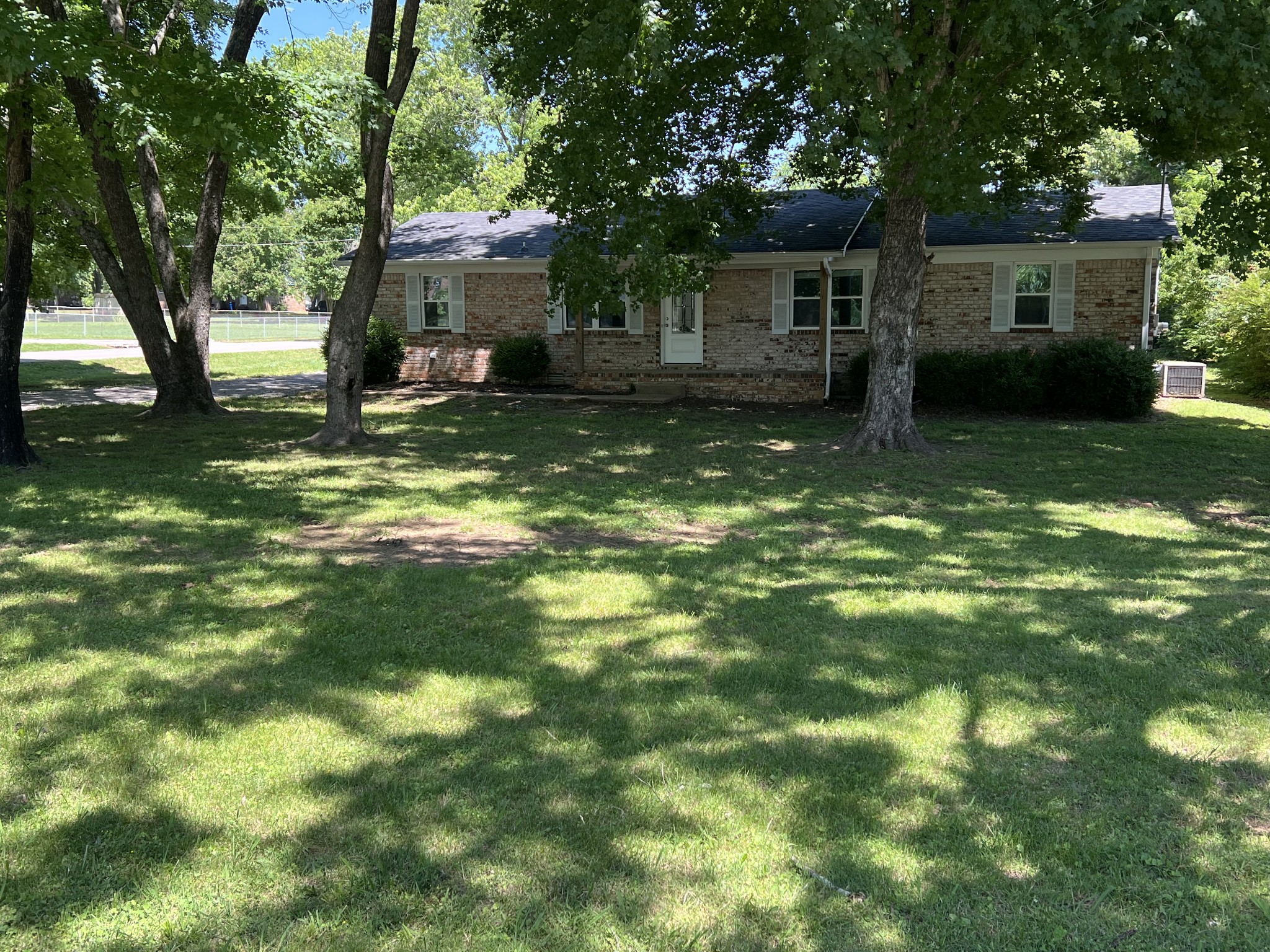 1846 Patrick Road Pulaski, TN 38478 - Photo 26 of 26 a backyard of a house with yard tree and outdoor seating