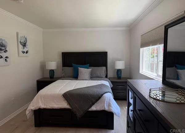 a bedroom with a bed and a window