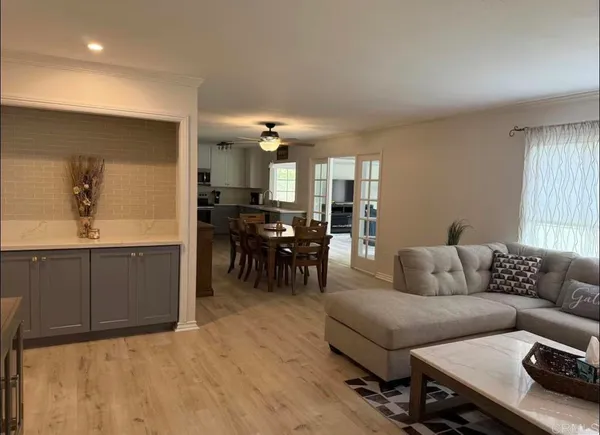 a living room with furniture and a dining table