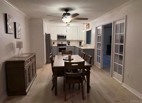 a view of a dining room with furniture and a chandelier