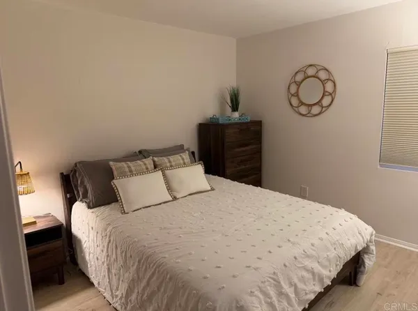 a bedroom with a bed and wall painting