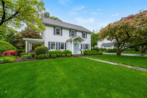 a front view of a house with a garden