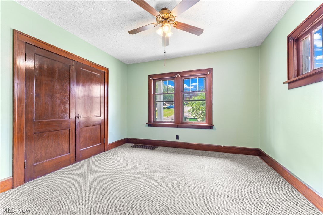 16 South State Street Rittman, OH 44270 - Photo 11 of 27 Unfurnished bedroom featuring a textured ceiling, carpet floors, and ceiling fan