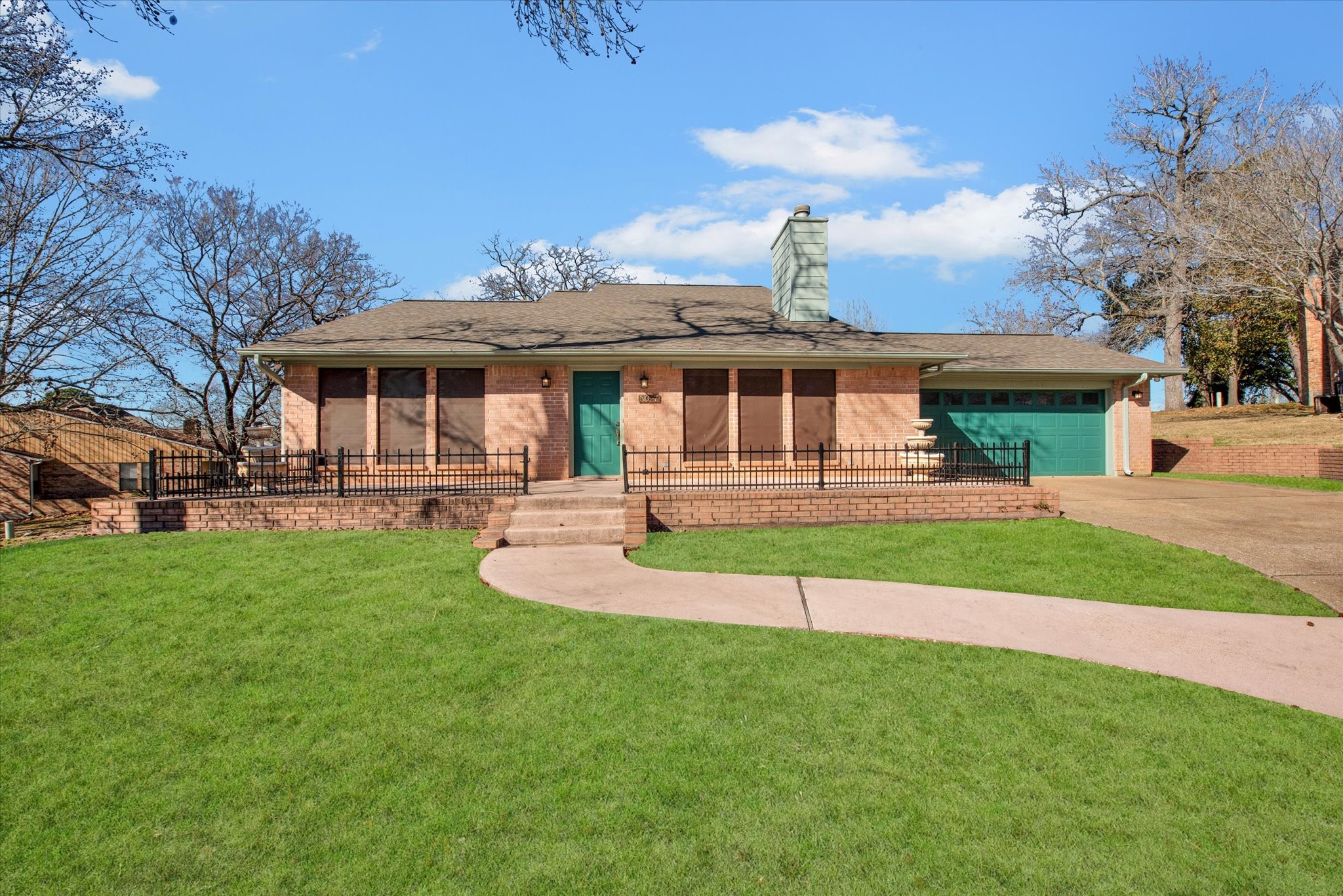 a front view of a house with a yard table and chairs