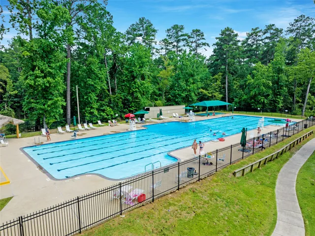 a view of a swimming pool with a yard and a mountain view