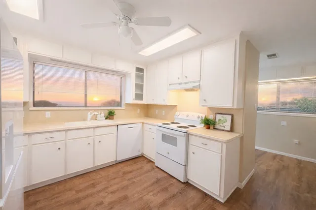 a kitchen with sink cabinets and wooden floor