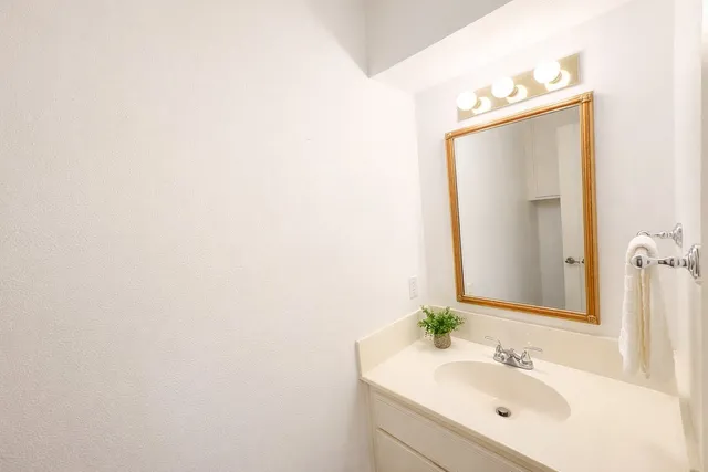 a bathroom with a sink and mirror