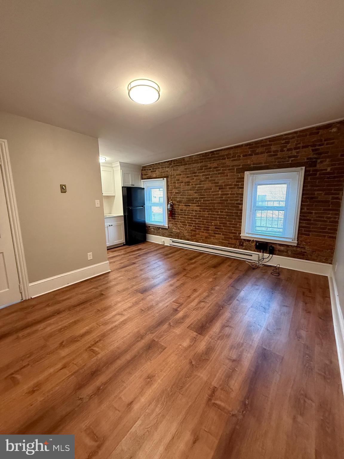 3 West Court Street, Unit 3 Doylestown, PA 18901 - Photo 5 of 12 a view of a livingroom with an empty space wooden floor and a window