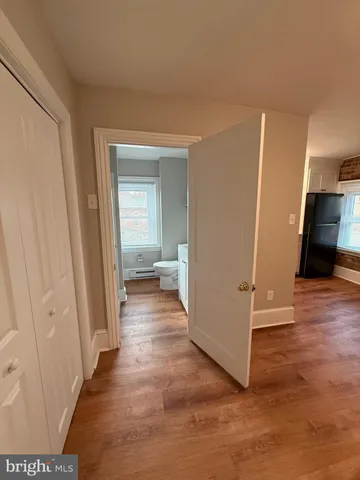 a view of a hallway with wooden floor