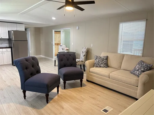 a living room with furniture and a ceiling fan