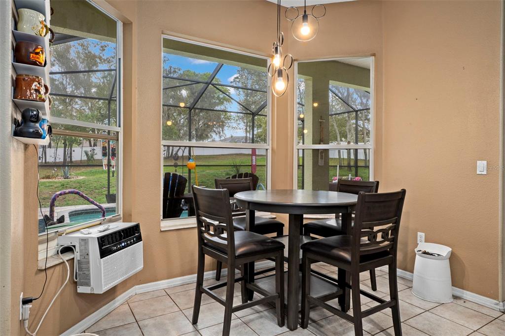 1378 Matthew Avenue Spring Hill, FL 34609 - Photo 11 of 56 a view of a dining room with furniture and chandelier
