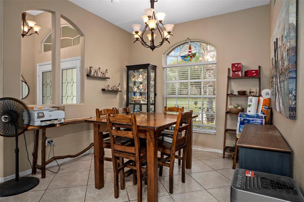 1378 Matthew Avenue Spring Hill, FL 34609 - Photo 15 of 56 a view of a dining room with furniture a chandelier and a window