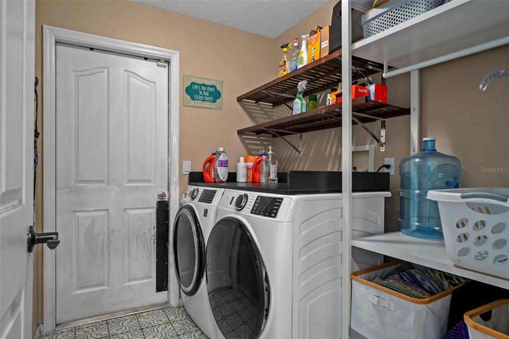 1378 Matthew Avenue Spring Hill, FL 34609 - Photo 16 of 56 a utility room with dryer washer and a view of living room