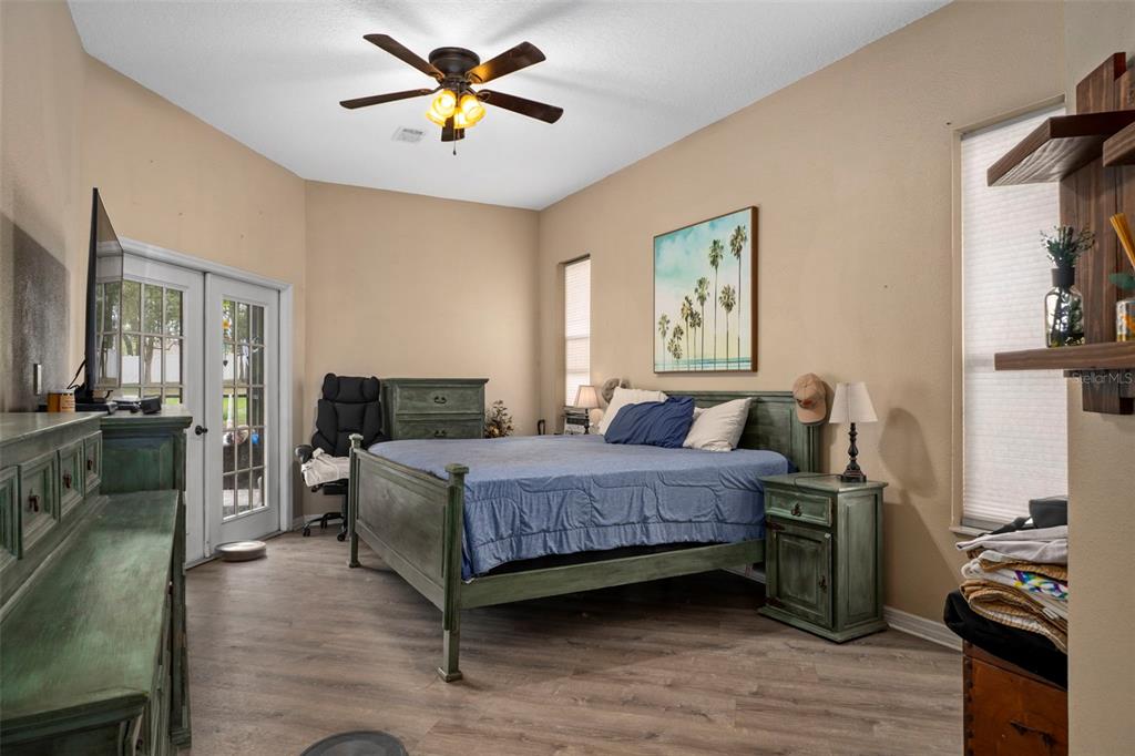 1378 Matthew Avenue Spring Hill, FL 34609 - Photo 17 of 56 a bedroom with a bed and a chandelier