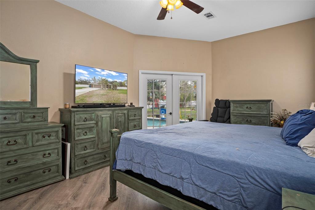 1378 Matthew Avenue Spring Hill, FL 34609 - Photo 18 of 56 a bedroom with a bed and a flat screen tv