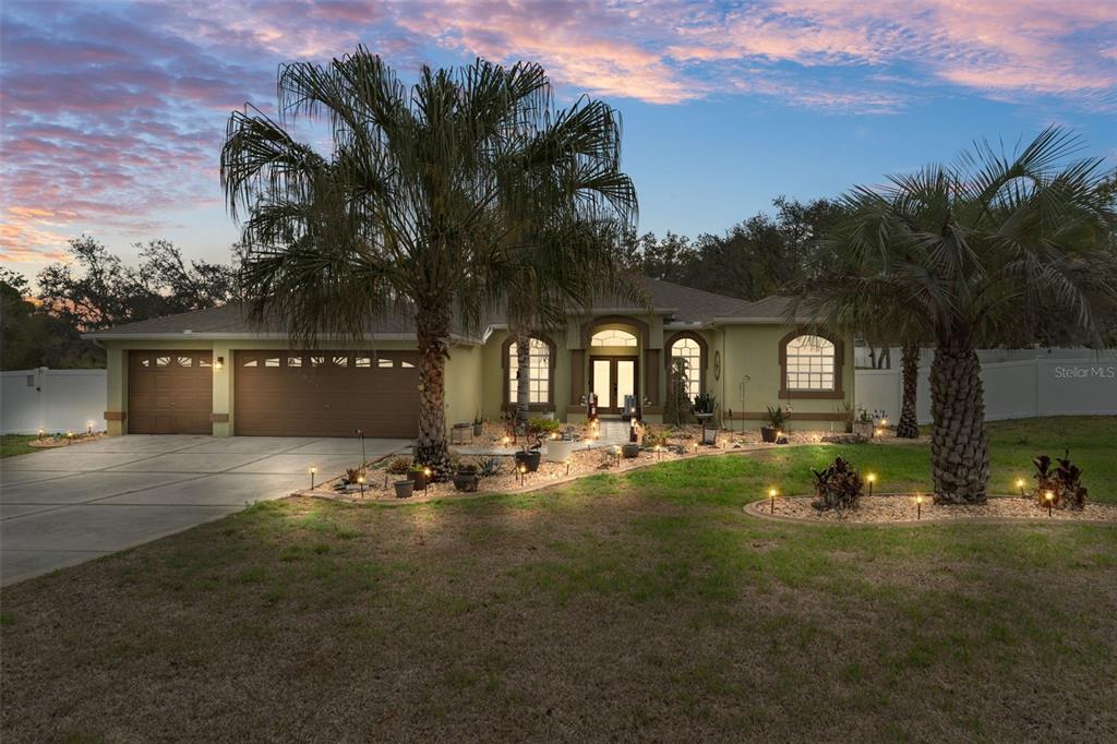 1378 Matthew Avenue Spring Hill, FL 34609 - Photo 2 of 56 a front view of a house with swimming pool and lake view