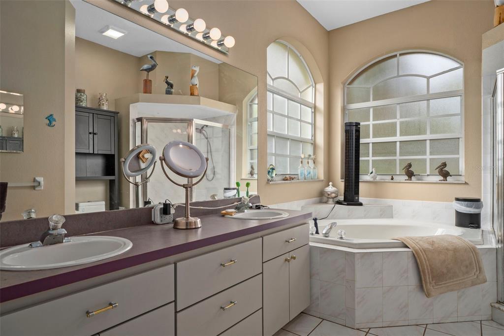 1378 Matthew Avenue Spring Hill, FL 34609 - Photo 21 of 56 a spacious bathroom with a granite countertop double vanity sink a mirror and a bathtub