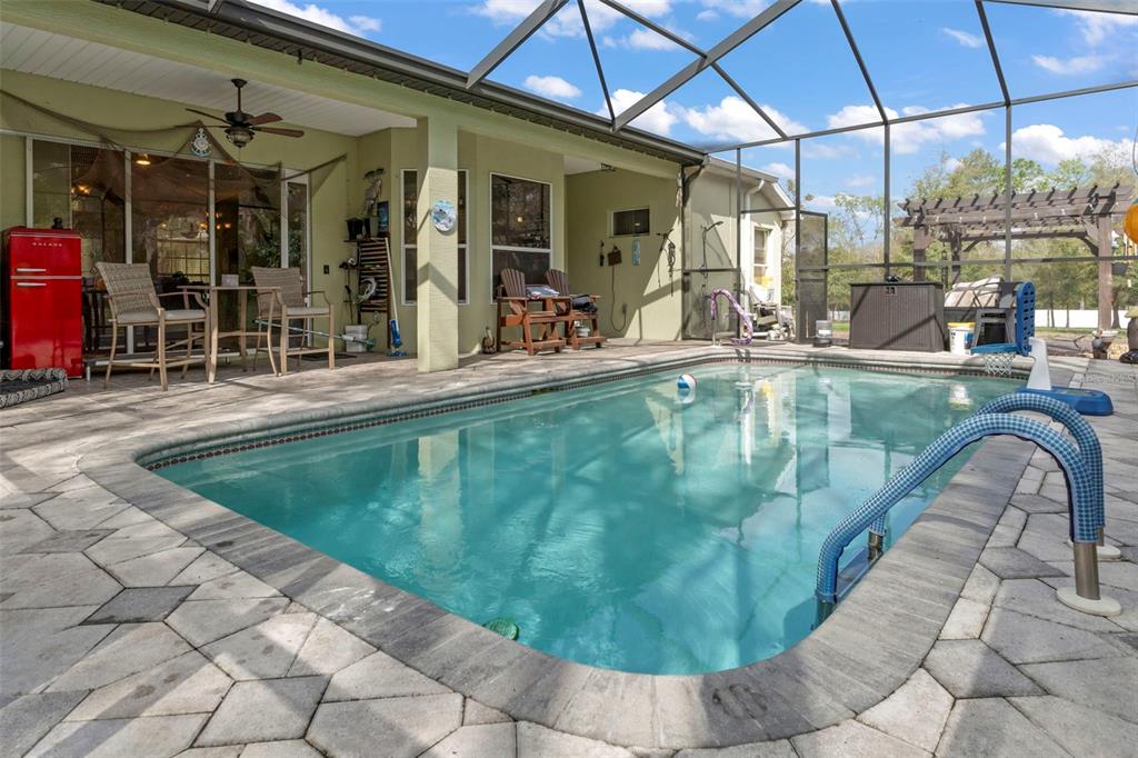 1378 Matthew Avenue Spring Hill, FL 34609 - Photo 32 of 56 a view of a swimming pool with a patio