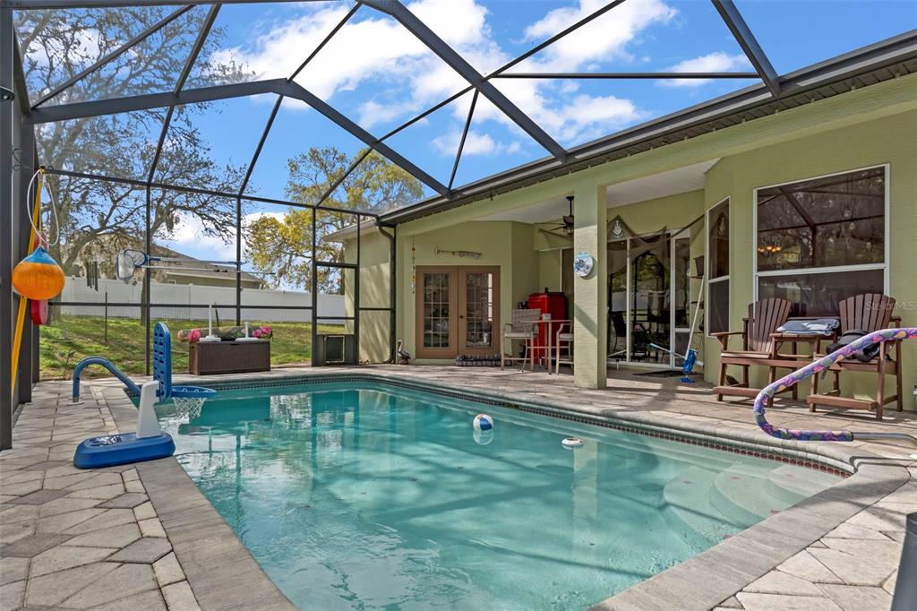 1378 Matthew Avenue Spring Hill, FL 34609 - Photo 33 of 56 a view of a swimming pool with a couches near a patio