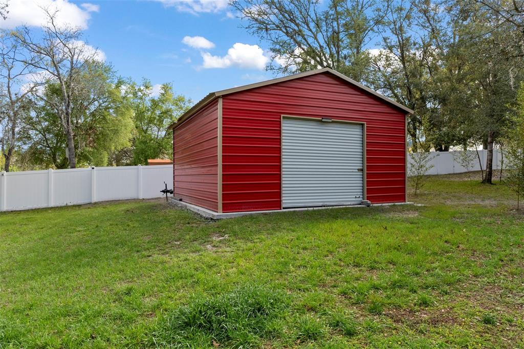 1378 Matthew Avenue Spring Hill, FL 34609 - Photo 40 of 56 a front view of a house with a garden