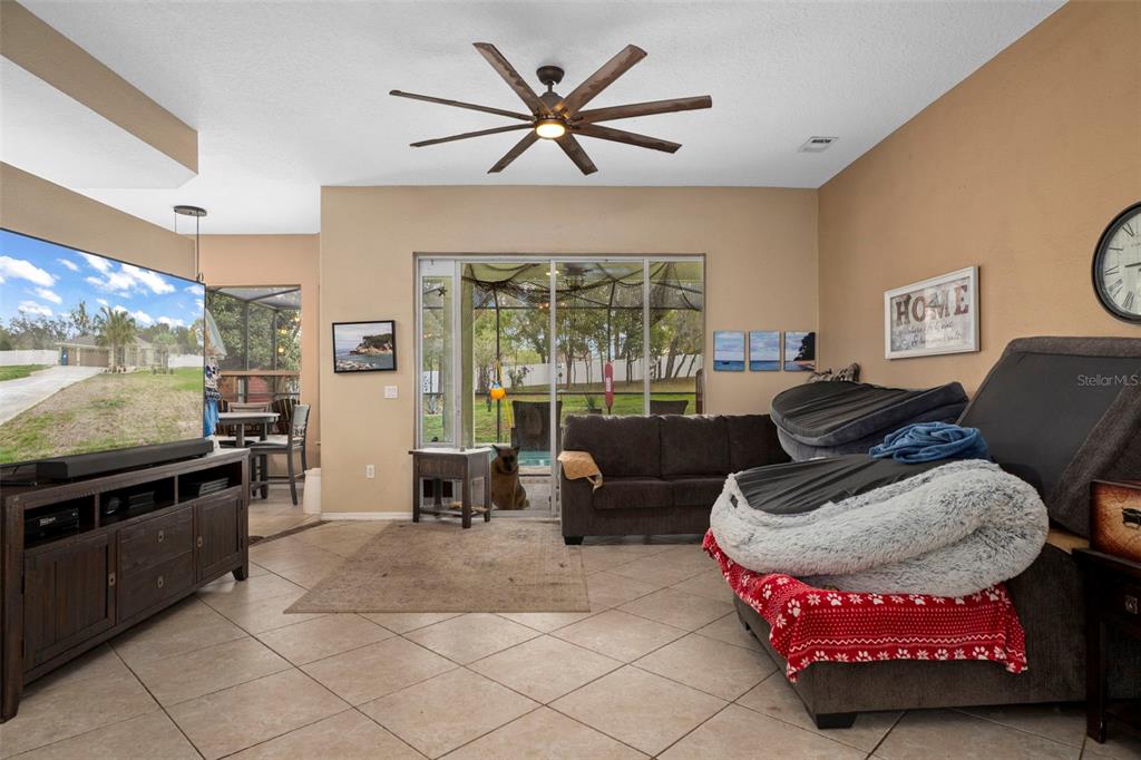1378 Matthew Avenue Spring Hill, FL 34609 - Photo 7 of 56 a living room with furniture and a flat screen tv