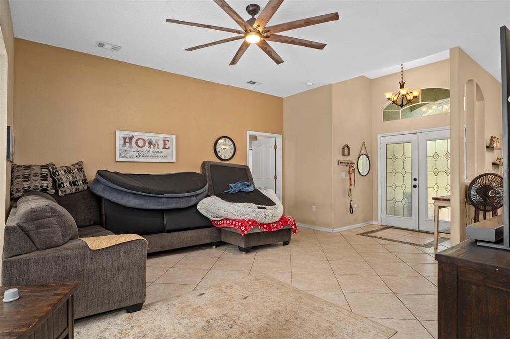 1378 Matthew Avenue Spring Hill, FL 34609 - Photo 9 of 56 a living room with furniture and a chandelier