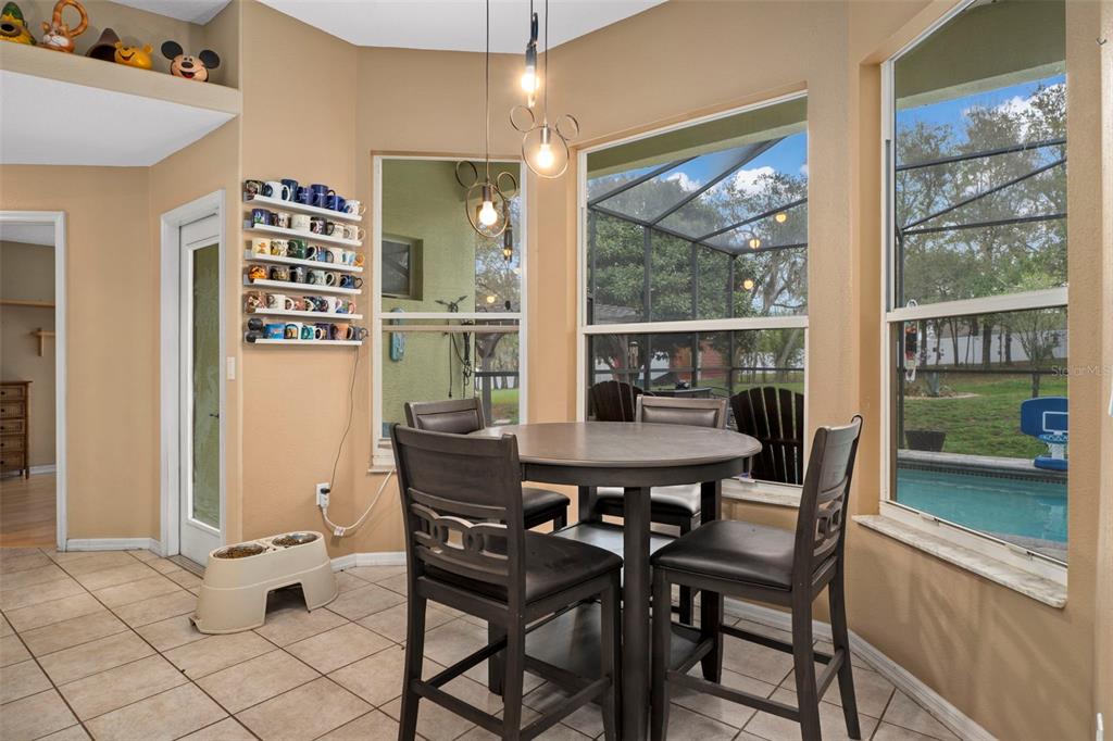 1378 Matthew Avenue Spring Hill, FL 34609 - Photo 10 of 56 a view of a dining room with furniture large windows and wooden floor