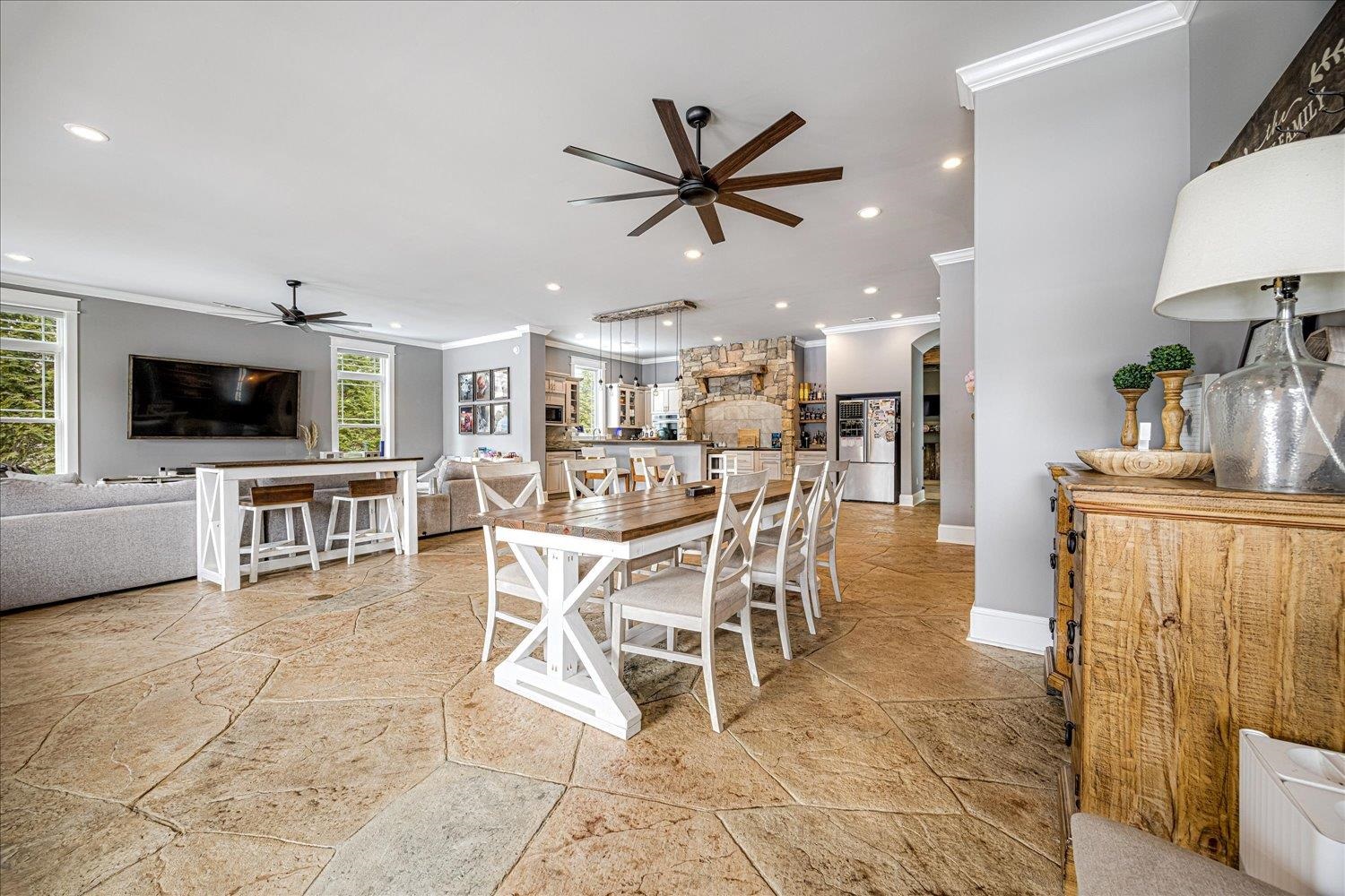 897 Burrowtown Road Mason, TN 38049 - Photo 12 of 37 Dining room featuring crown molding, stone tile floors, ceiling fan, arched walkways, and recessed lighting