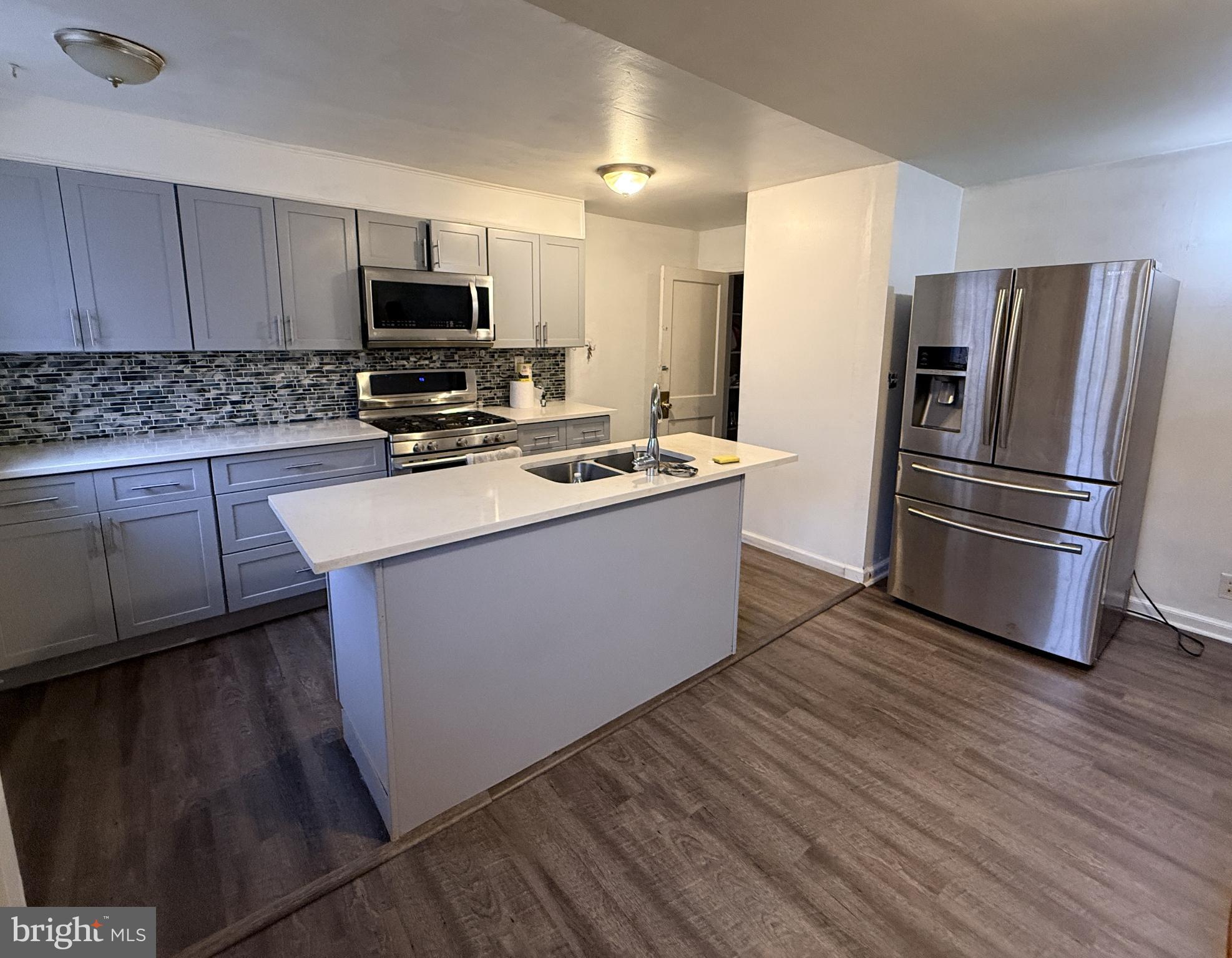 321 Hampden Road Upper Darby, PA 19082 - Photo 3 of 11 a kitchen with wooden cabinets and stainless steel appliances