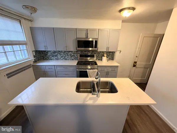 a kitchen with a sink a stove and refrigerator