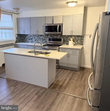 a kitchen with stainless steel appliances a refrigerator sink and microwave