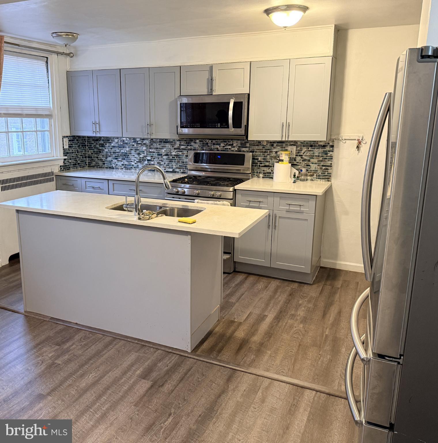 321 Hampden Road Upper Darby, PA 19082 - Photo 5 of 11 a kitchen with stainless steel appliances a refrigerator sink and microwave