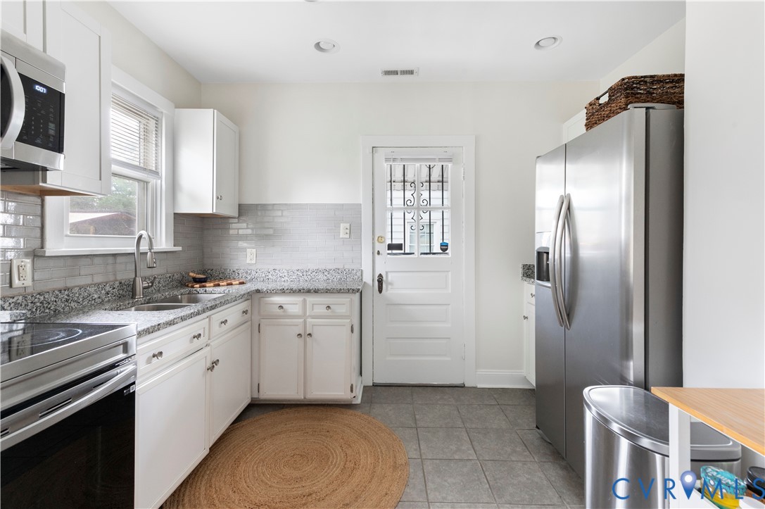 613 Rothesay Road Richmond, VA 23221 - Photo 10 of 36 Kitchen featuring white cabinetry, granite counter