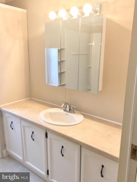 109 Rodeo Circle Middle River, MD 21220 - Photo 22 of 24 a bathroom with a sink and a mirror