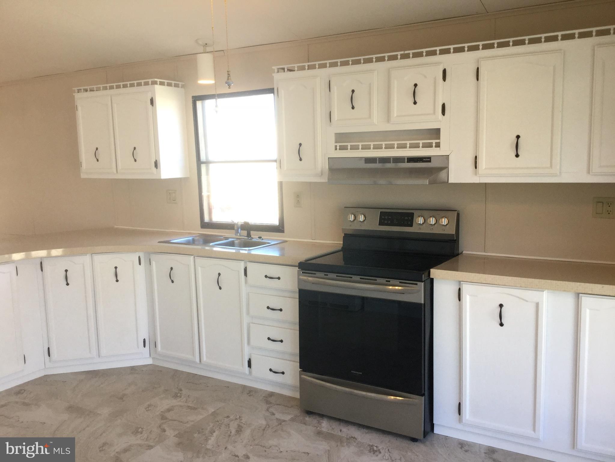 109 Rodeo Circle Middle River, MD 21220 - Photo 5 of 24 a kitchen with granite countertop white cabinets and a stove