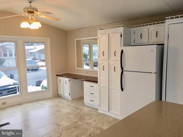 109 Rodeo Circle Middle River, MD 21220 - Photo 6 of 24 a kitchen with white cabinets and white stainless steel appliances
