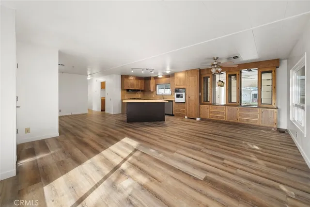 a view of kitchen with furniture and refrigerator
