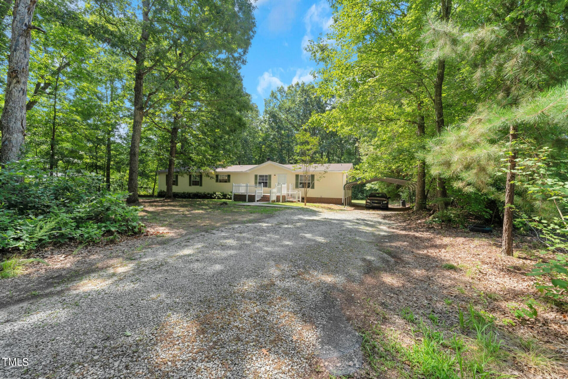 2416 Lucy Garrett Road Roxboro, NC 27574 - Photo 2 of 25 a view of a field with trees in the background