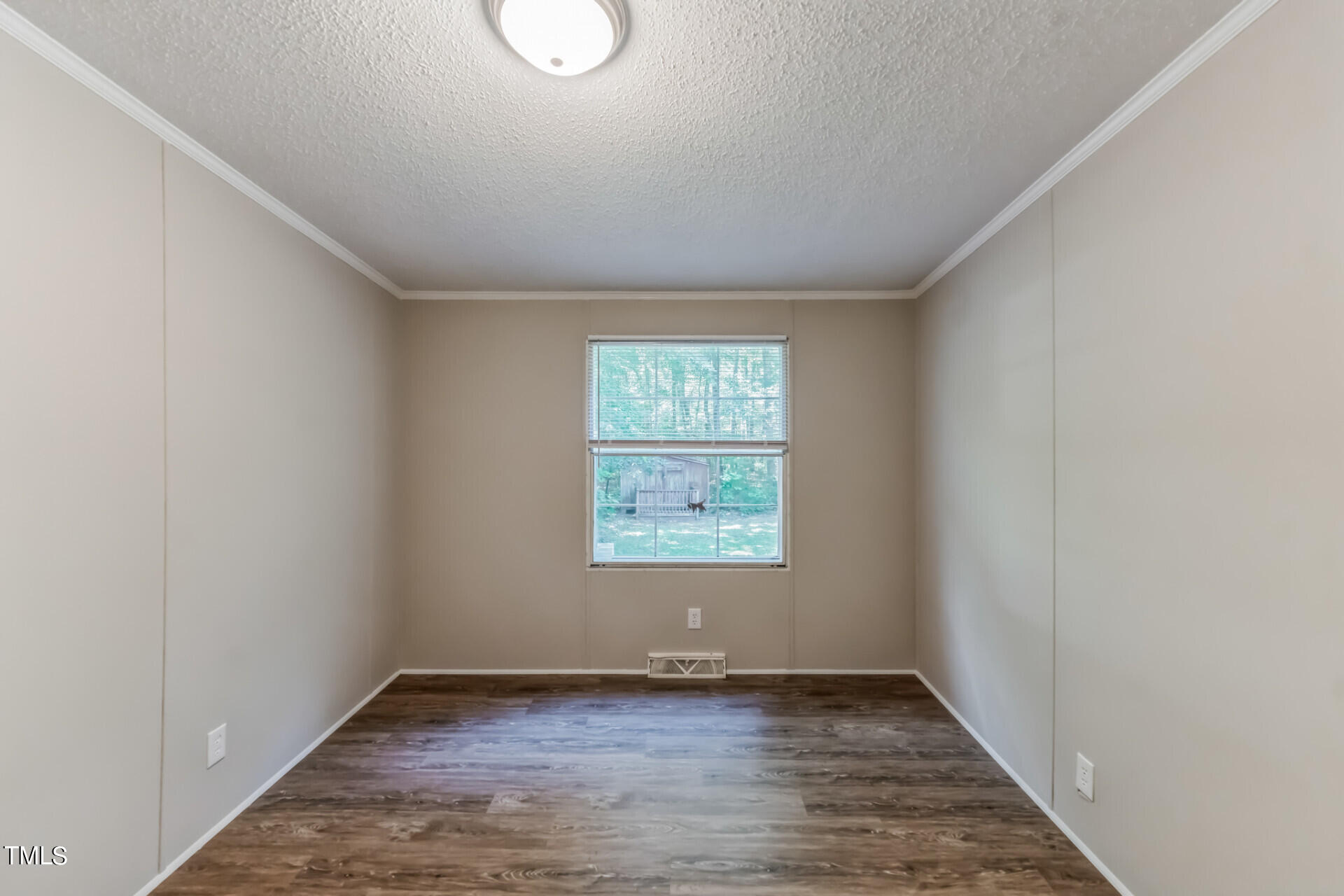 2416 Lucy Garrett Road Roxboro, NC 27574 - Photo 25 of 25 an empty room with wooden floor and windows