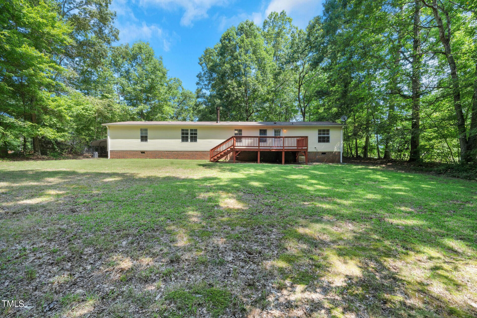 2416 Lucy Garrett Road Roxboro, NC 27574 - Photo 4 of 25 a view of a house with a big yard and large trees